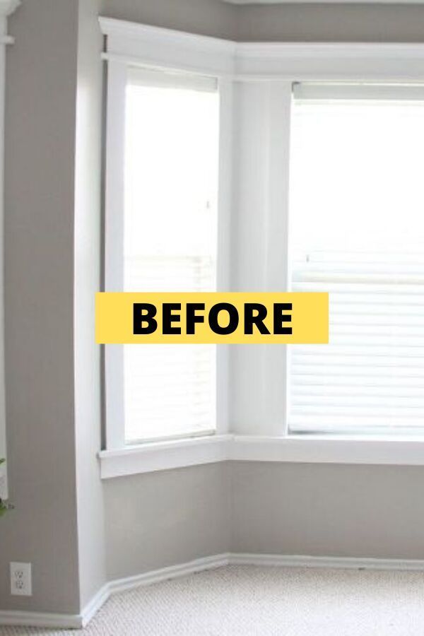 an empty room with the words before and after painted yellow in front of it's windows