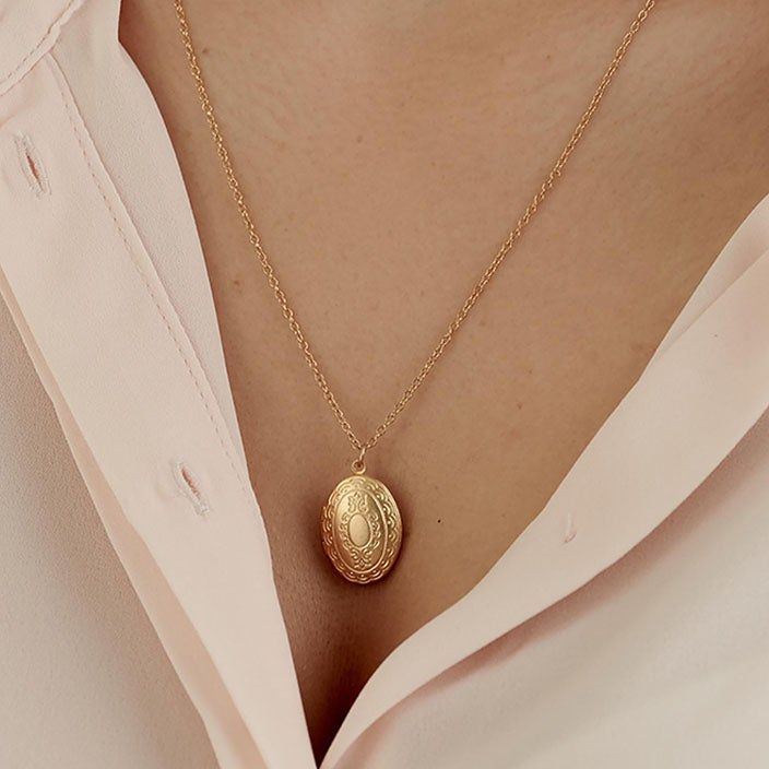 This 14K gold-filled photo locket pendant necklace is handmade especially to keep your memories close. With a vintage jewelry inspiration in mind, the gold locket reminds us of a Victorian necklace. PRODUCT DETAILS: The 14K gold-filled locket pendant measures about 16mm wide and 24mm long. The delicate gold chain is customizable. Choose your ideal length from the menu (15-24 inches) This necklace has an oval-shaped locket pendant with Victorian-inspired detailing. Keep something special in this Luxury Round Pendant Locket Necklace With Complimentary Chain, Luxury Polished Locket Necklace With Round Pendant, Luxury Vintage Locket Necklace, Luxury Elegant White Gold Locket Necklace, Antique Luxury Locket Necklace For Formal Events, Luxury Oval Pendant Locket Necklace, Cheap Vintage Gold Locket Necklace, Luxury Oval Yellow Gold Locket Necklace, Gold Locket Necklace In Brass