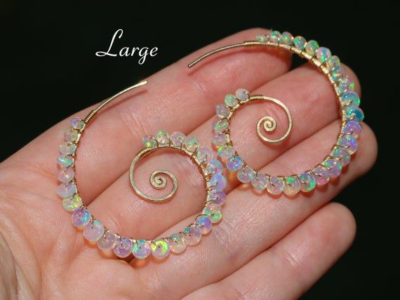 THE JEWELRY IS SHIPPED via DHL EXPRESS (2-5 days delivery door to door). THE DHL SHIPPING COST IS INCLUDED IN THE PRICE.The Sea Shell Earrings - Ethiopian Opal Wire Wrapped Spiral Hoop Earrings, Genuine Welo Opal EarringsThe earrings come with silicone earring backs.► Measurements / Details:- Length of the spiral hoops including Opals: Small - 1.25" (~3.2 cm); Large - 1.5" (~3.7 cm)- Gold: High quality Gold Filled- Silver: High quality Sterling Silver- The earrings come with silicone earring bac Crystal Wraps, Ethiopian Opal Earrings, Sea Shell Earrings, Fire Opal Earrings, Spiral Earrings, Hammered Gold, Handmade Wire Jewelry, Wing Earrings, Gold Filled Earrings