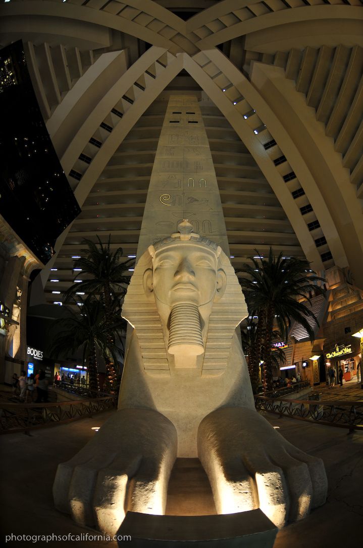 an elephant statue is lit up in the middle of a building with arches above it