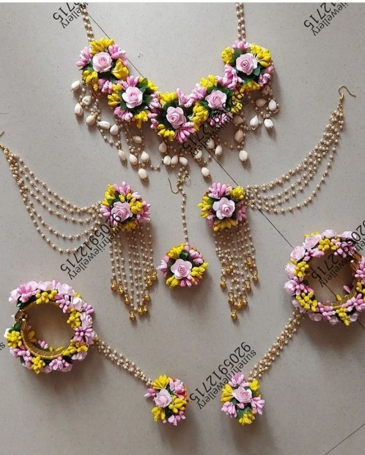 several necklaces with flowers and pearls on them