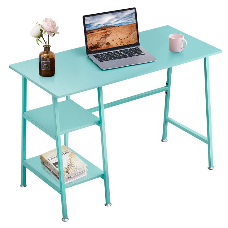 a laptop computer sitting on top of a blue desk next to a vase with flowers