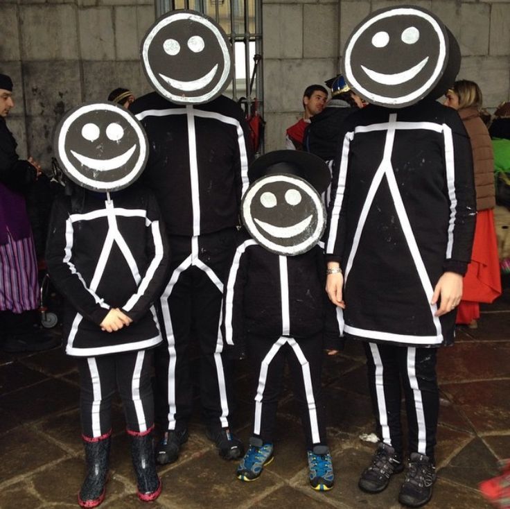 three people dressed in black and white are standing next to each other with faces painted on them