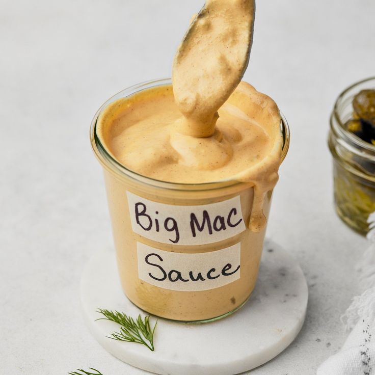 a jar of sauce with a wooden spoon sticking out of it