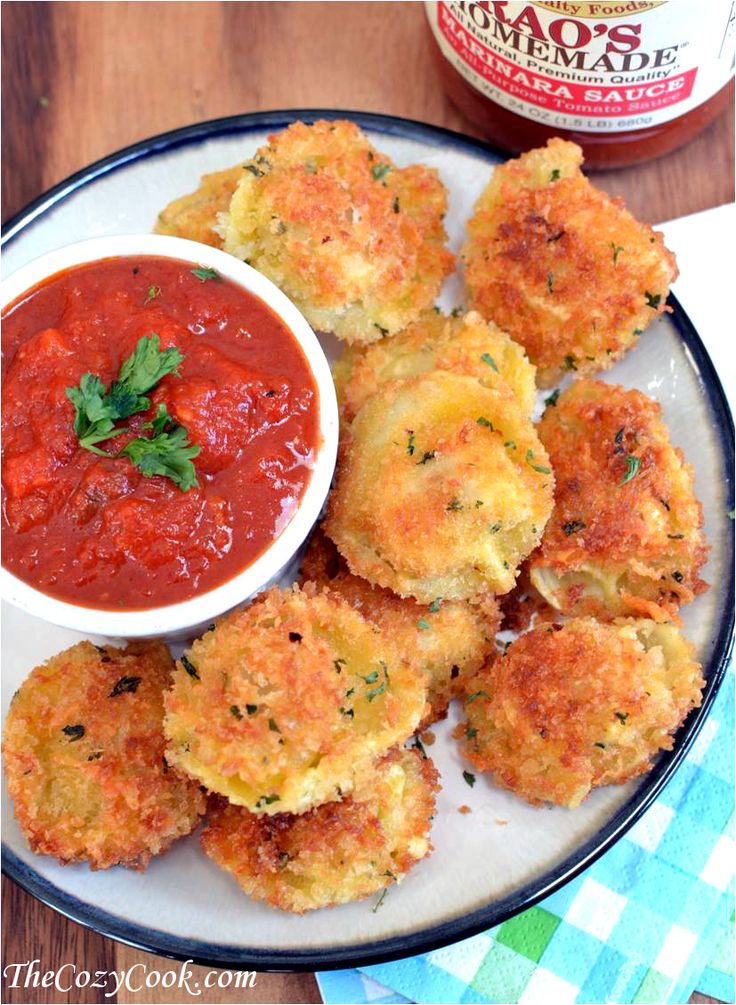 crab cakes with marinara sauce on a plate