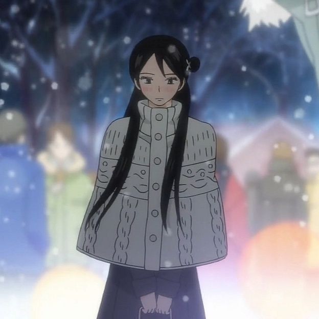 a woman with long black hair standing in the snow