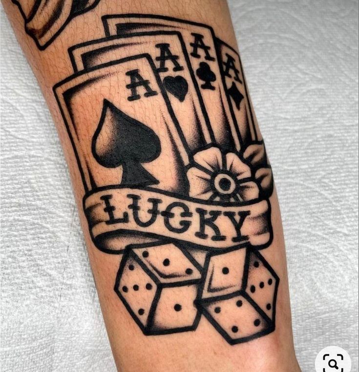 a black and white tattoo with playing cards on it