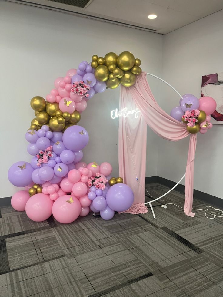 balloon arch with pink, purple and gold balloons