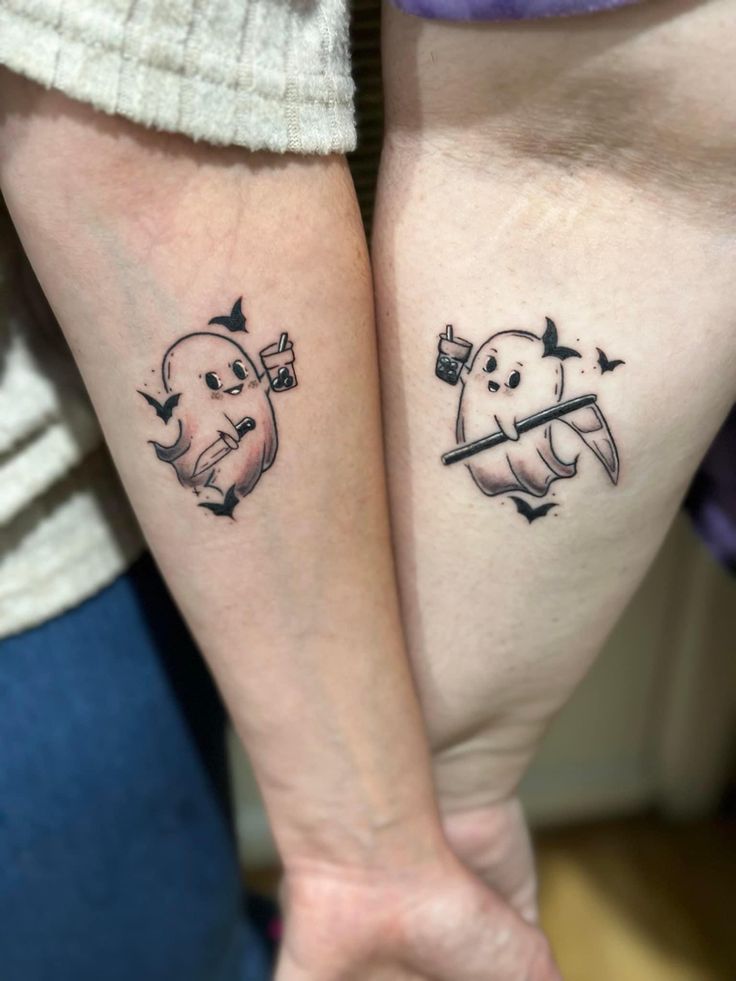 two people with matching tattoos on their arms