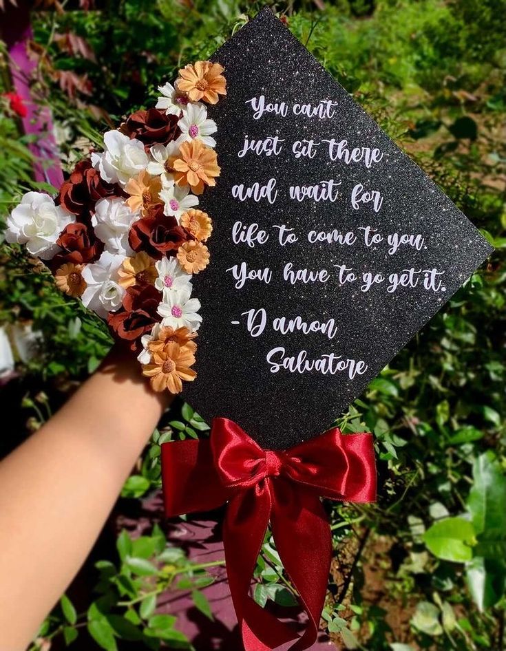 someone is holding up a graduation cap with flowers on it and the words you can't get there and wait for life to come too