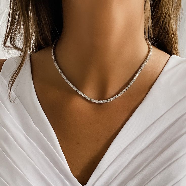 Compliment any look with Alexandra’s stunning and truly timeless, classic prong set CZ Tennis Necklace. Set in fine sterling silver, it’s the one necklace that can be both fancy and casual at the same time. From your big day to everyday, a tennis necklace brightens up any look. Details:• Round Brilliant Cubic Zirconia Stones• Rhodium Plated Sterling Silver • Length: 16" • Safety Clasp • Stone Size: from 4mm Bridal Tennis Necklace, Silver Tennis Necklace, Big Silver Necklace, Tennis Necklace Diamond, Prom 2024, Necklace Everyday, Diamond Tennis Necklace, Bridal Jewelry Collection, Hot Jewelry