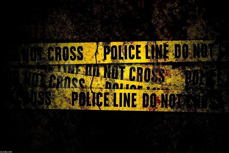 there are two yellow and black signs on the wall that say police line don't cross