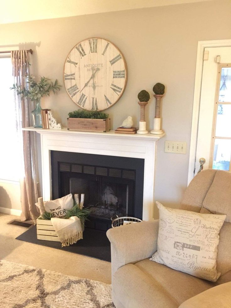 a living room filled with furniture and a large clock on the wall above the fireplace