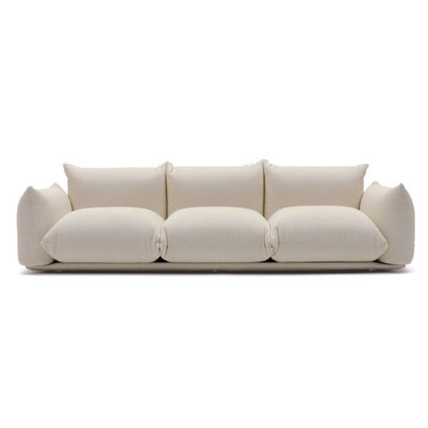 a white couch with four pillows on it