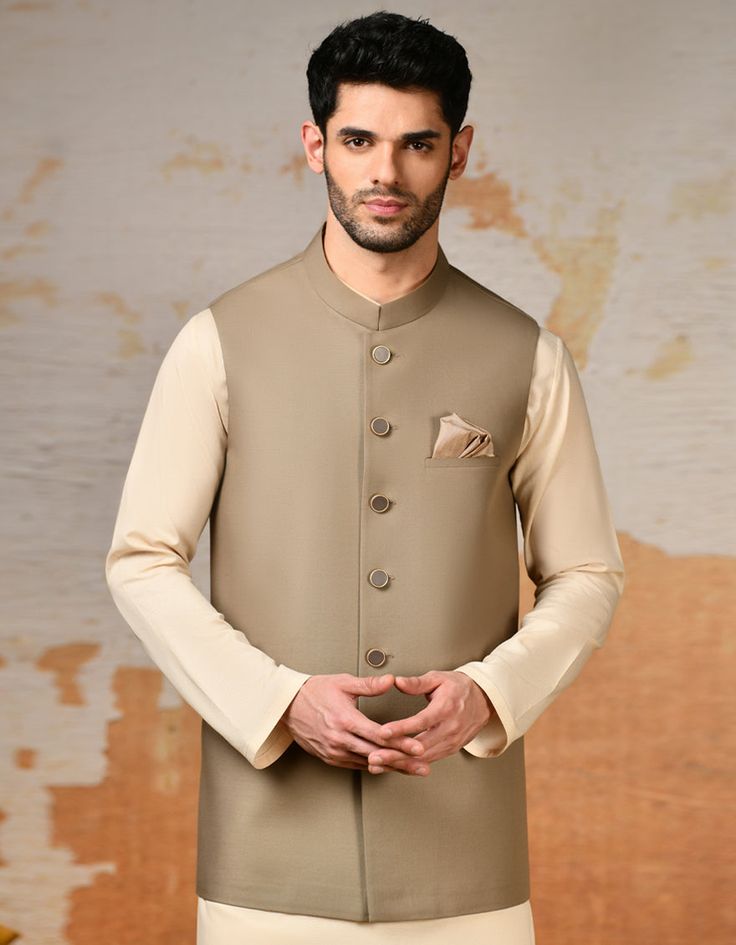 Elevate your traditional attire with this Beige blended waistcoat, a timeless piece that adds sophistication to your look. Crafted with meticulous attention to detail, it features a classic design that complements any kameez shalwar or kurta. Perfect for weddings, festive occasions, or cultural events, this waistcoat i Formal Beige Unstitched Suit, Fitted Kurta With Stand Collar For Workwear, Formal Beige Salwar Kameez For Eid, Fitted Stand Collar Kurta For Workwear, Classic Fitted Traditional Wear For Eid, Elegant Semi-formal Straight Kurta Set, Elegant Outerwear With Dabka, Elegant Semi-formal Set With Straight Kurta, Classic Outerwear For Wedding