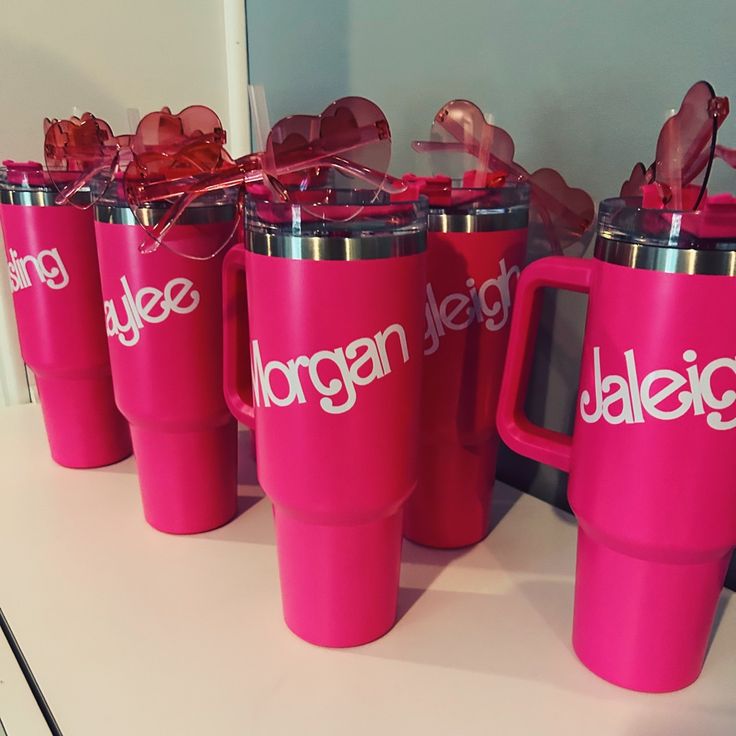 four pink coffee mugs sitting on top of a counter