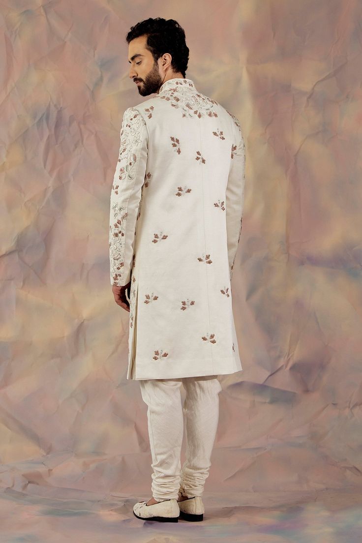 White hand embroidered sherwani with zardozi and aari in floral motifs. Paired with matching pintuck kurta and churidar.
Component: 3
Pattern: Embroidered
Type Of Work: Floral
Neckline: Mandarin
Sleeve Type: Long
Fabric: Linen Silk
Color: White
Other Details: 
Floral motifs
Occasion: Groom,Wedding - Aza Fashions Jatin Malik, Embroidered Sherwani, White Hand, Churidar, Floral Motifs, Custom Tailoring, Wedding Groom, Embroidered Silk, Handmade Shoes