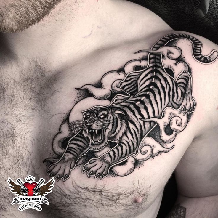 a man with a tiger tattoo on his chest