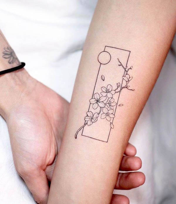 a woman's arm with a flower tattoo on the left side of her arm