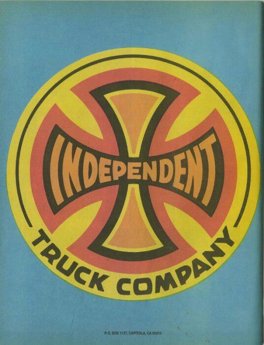 the independent truck company logo on a blue and yellow background with an orange cross in the center