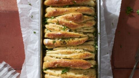 a pan filled with bread covered in herbs