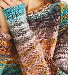 a close up of a person wearing a sweater and holding their hand on her shoulder