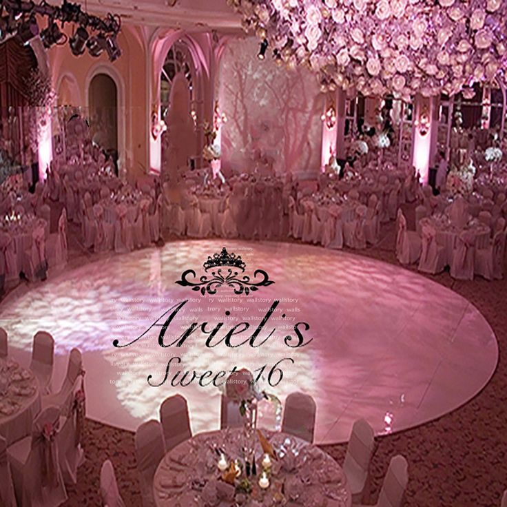 the inside of a ballroom with tables and chairs set up for a wedding reception in pink