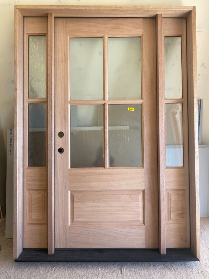 a wooden door with glass panels on it