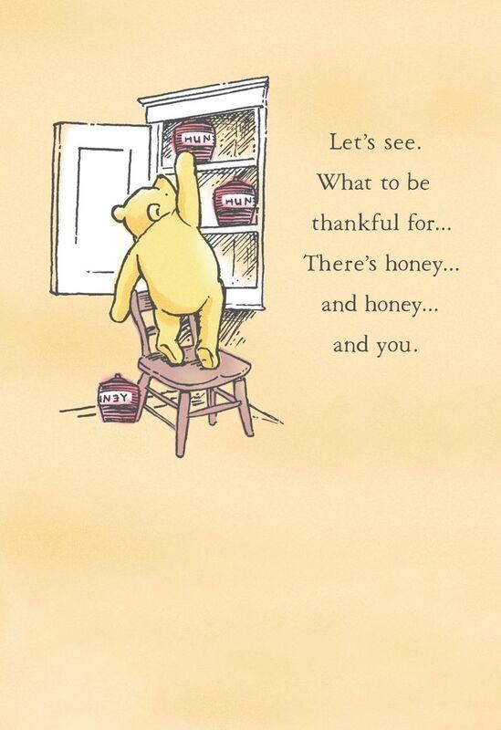 a winnie the pooh sitting in a chair looking into an open refrigerator