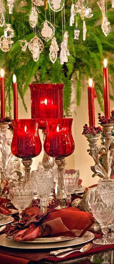 a table topped with lots of red glassware and christmas decorations on top of it