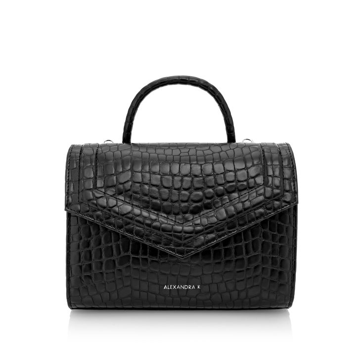 DELIVERY TIME 14-21 WORKING DAYS crocodile pattern handbag medium modern vegan bag top handle bag innovative fabric one pocket inside detachable medium-thick strap included stamped brand logo on the front made with care and attention to every detail locally crafted The FAITH MIDI Croco handbag, in classic black, showcases elegance and practicality. This crocodile pattern handbag suits various styles, from laid-back to formal. Made from innovative corn fabric, it's not only chic but eco-friendly. Midi Top, K Logo, K Logos, Vegan Bag, Medium Sized Bags, Vegan Handbags, Medium Handbags, Handbag Patterns, Vegan Bags