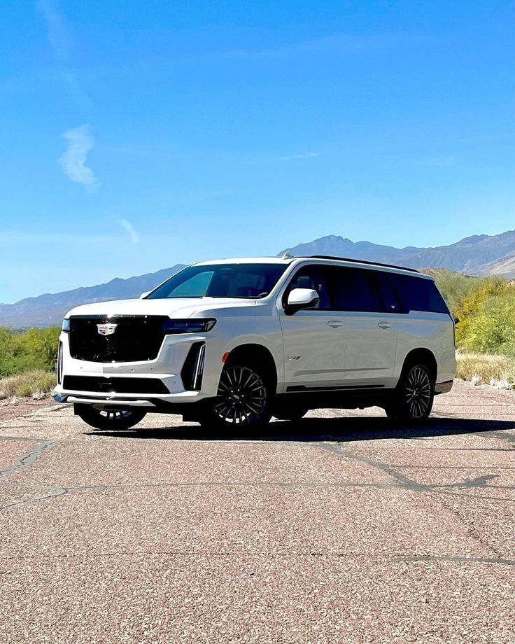 a white suv is parked in the desert