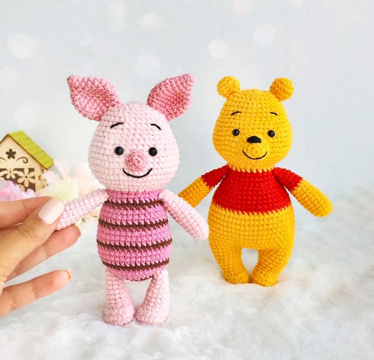 two crocheted winnie the pooh and piglet dolls