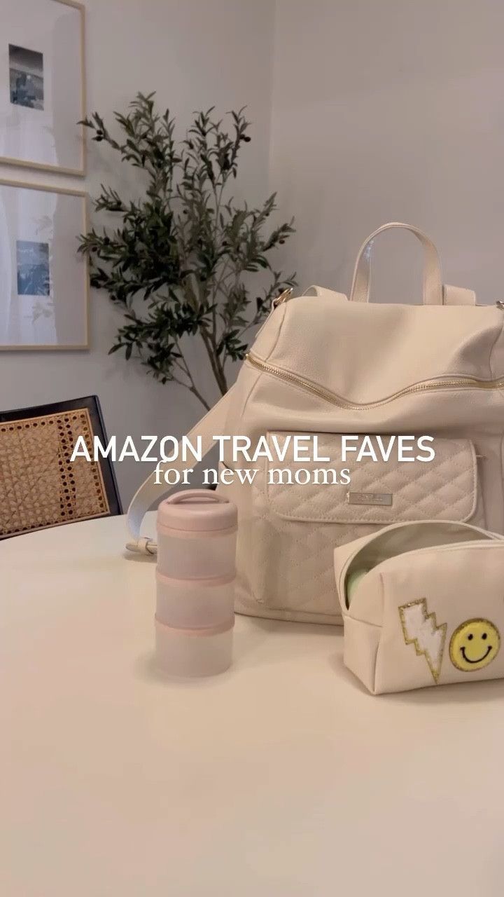 a white bag sitting on top of a table next to two cups and a vase