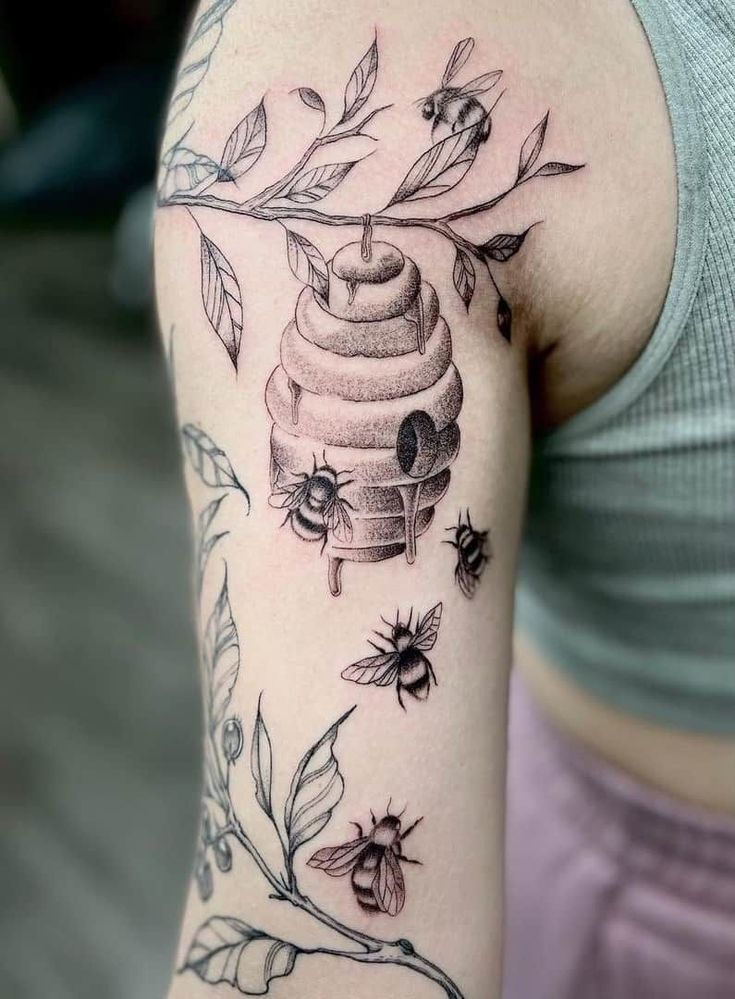 a woman with a beehive tattoo on her arm