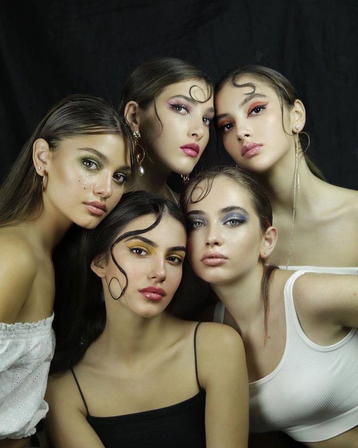 the models are posing together with their faces painted