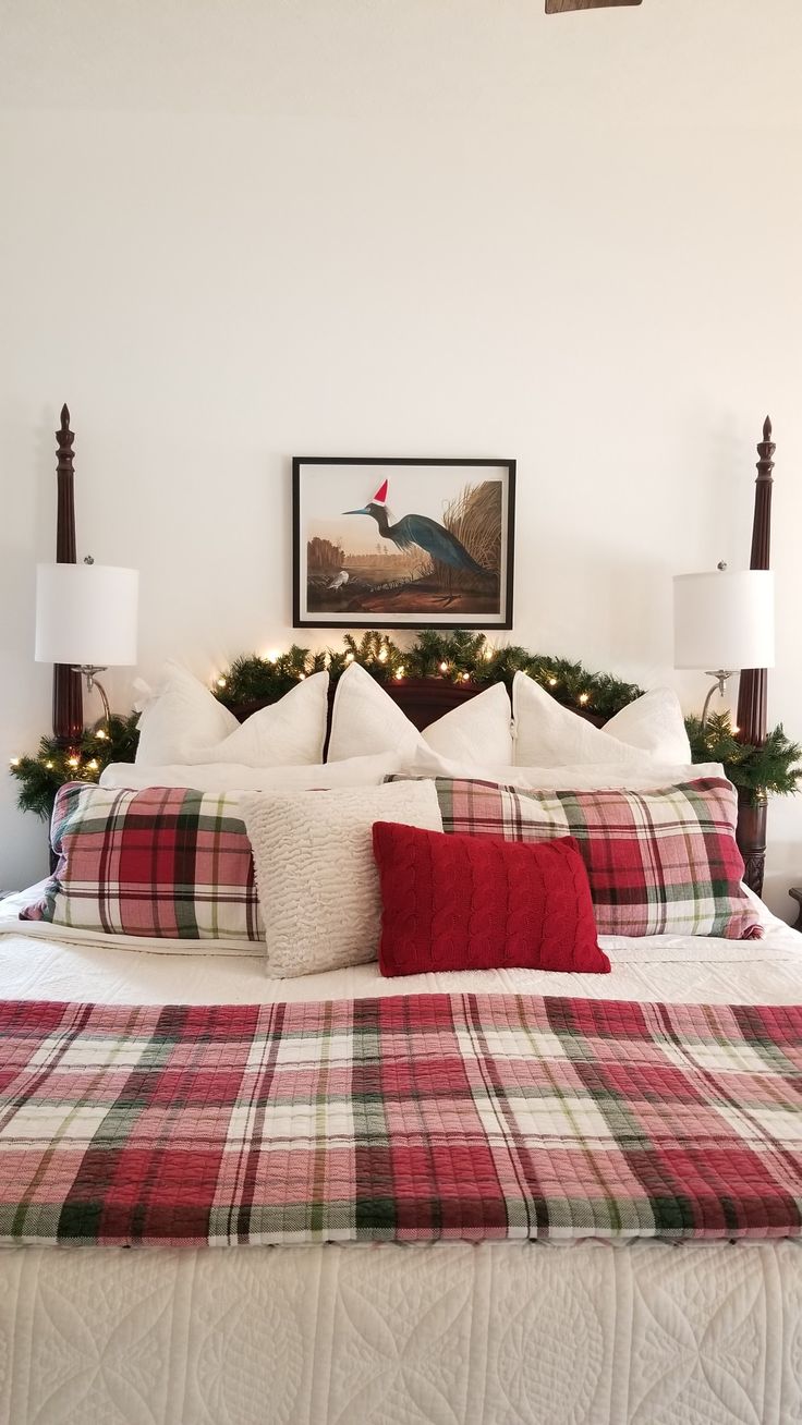 a bed with plaid comforter and pillows in a bedroom