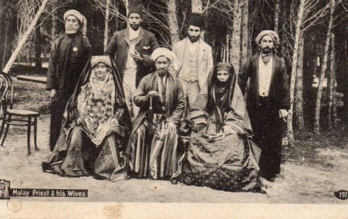 an old black and white photo of people standing in the woods with their heads bowed