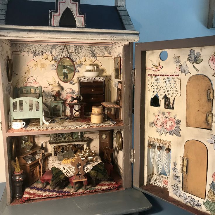 an open doll house with furniture and accessories in it's display case on a table