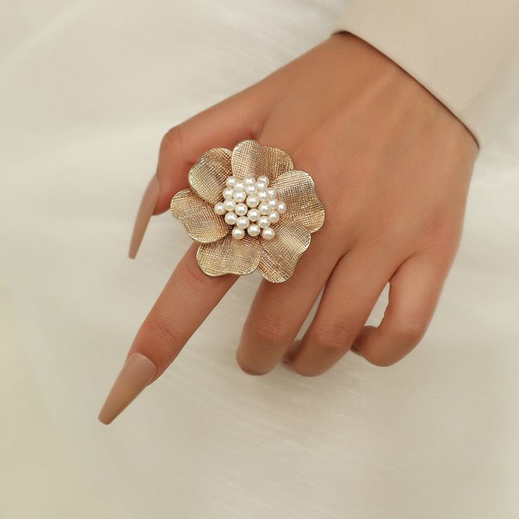 The ring is made from gold-plated over brass and set with lovely resin pearls, featuring a large flower design. This subtle back-to-basics accessory will be an excellent gift for a woman in your life. It would be perfect for Mother's Day, Wedding Day, Birthday, Anniversary or any other occasion. 👌 M A T E R I A L• Gold-plated Brass• Resin Pearls• This product is hypoallergenic (nickel free) and tarnish resistant 📏 S I Z E• Length: 5.6 cm (2.2 inch)• Weight: 6.8 g Fashion Romantic, Color Rings, Romantic Fashion, Costume Jewelry Rings, Adjustable Jewelry, Wedding Party Jewelry, Bff Gifts, Women Ring, Vintage Bridal