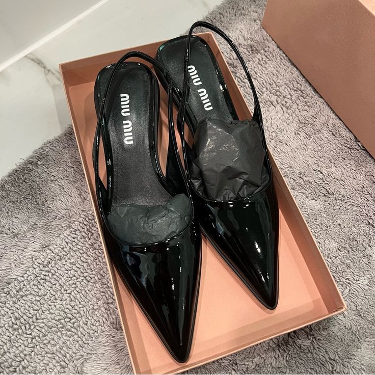 New, Never Worn Miu Miu Black Patent Leather Slingback Kitten Heels. Size 38. I’m Normally A 38.5 And These Fit So I Think They May Run A Bit Big. Incredibly Small White Scuffs Shown In Two Photos. Comes With Box, But No Dust Bag. 100% Authentic. Still For Sale On Frwd.Com For $910. From Website: These Patent Leather Slingback Pumps Blend Materials, Colors And Stylistic Codes Typical Of Dynamic Sports Shoes And Tropes Of Femininity. Patent Leather Upper With Rubber Sole Made In Italy Slingback S Designer Low Heel Slingback Pumps For Office, Luxury Black Ankle Strap Kitten Heels, Patent Leather Slingback Sandals With 4-inch Heel, Black Pointed Toe Slingback Sandals For Evening, Patent Leather Open Heel Slingback Pumps For Evening, Designer Patent Leather High Heel Slingback Pumps, Designer Patent Leather Slingback Pumps High Heel, Luxury Pointed Toe Sandals For Office, Patent Leather Slingback Heels For Evening