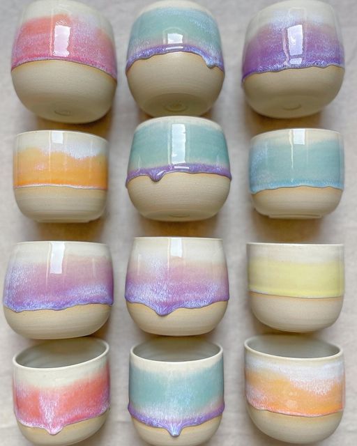 there are many bowls that have different designs on them, each one is painted with pastel colors