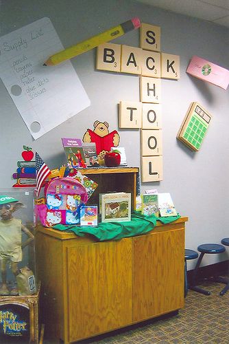 an office cubicle with toys and letters on the wall