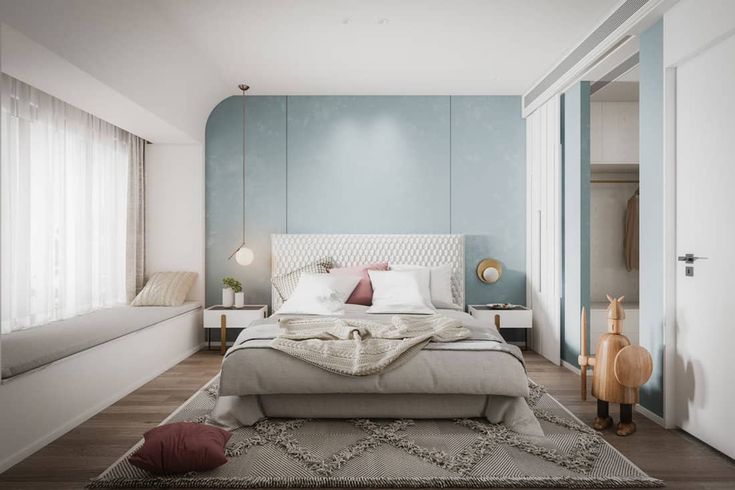 a bedroom with blue walls and white bedding, rugs on the wooden floor