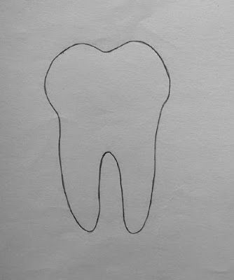 a drawing of a tooth on a piece of paper