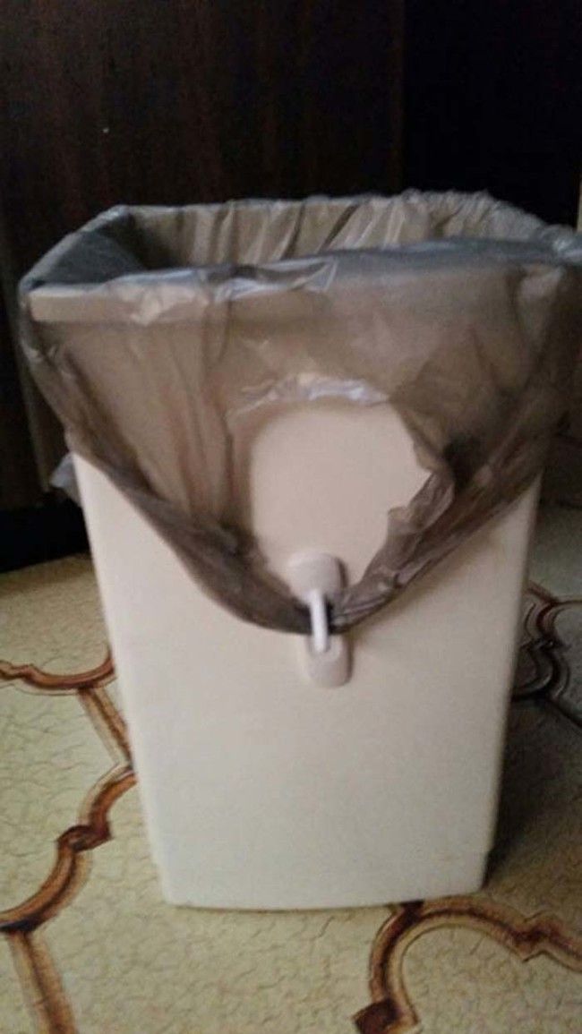 a white box sitting on top of a bed covered in mosquito netting with a mouse