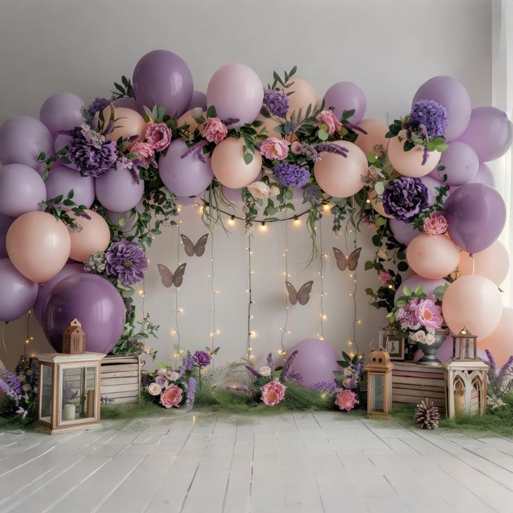 a room decorated with balloons and flowers on the wall is filled with purple, pink and white decorations