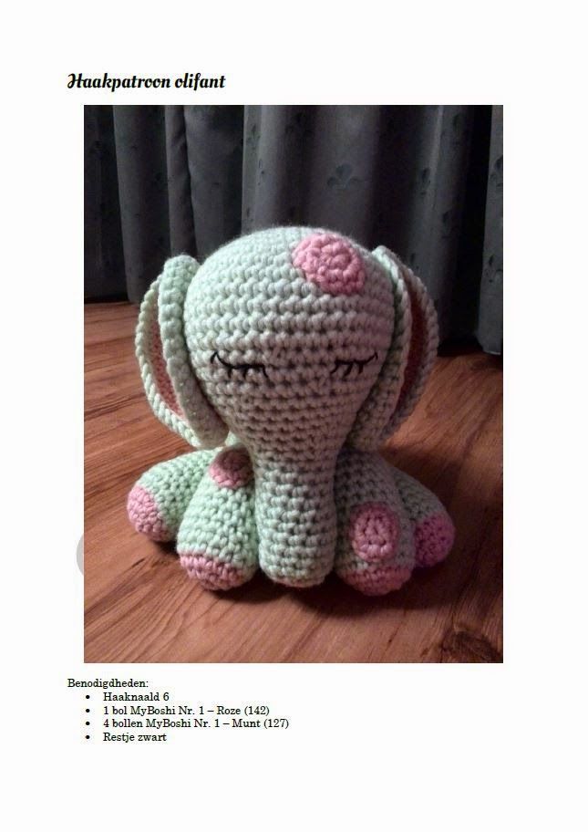 a crocheted elephant sitting on top of a wooden floor next to a curtain