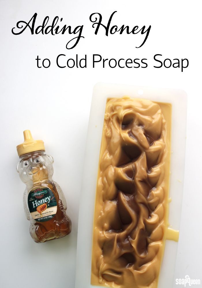 a soap bar sitting on top of a white counter next to a bottle of honey