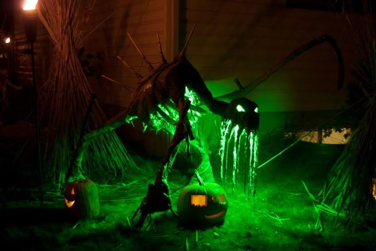 an outdoor halloween scene with pumpkins and lights in the grass, including a green dragon